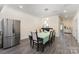 Bright dining room features stainless fridge, hardwood floors, and elegant furnishings at 131 Swink Sw St, Concord, NC 28027