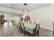 Dining room leads to a modern kitchen and bright living space with hardwood floors at 131 Swink Sw St, Concord, NC 28027