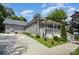 Exterior view of home showcasing driveway, gray siding, and a charming front porch at 131 Swink Sw St, Concord, NC 28027