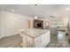 Kitchen island with granite countertop, seating, and an open floor plan to living room at 131 Swink Sw St, Concord, NC 28027