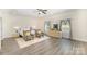 Main bedroom has ample natural light, hardwood floors, and neutral color palette at 131 Swink Sw St, Concord, NC 28027