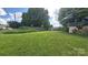 Expansive backyard showcasing a lush green lawn and a peaceful setting, ideal for outdoor activities at 1313 Maiden E Rd, Maiden, NC 28650