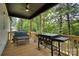 Comfortable back porch with wood floors, a grill, ceiling fan, and seating area overlooks a wooded yard at 141 Ole Eastpointe Dr, York, SC 29745