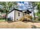 Backyard with black metal fence, wooden stairs to porch, and white painted brick exterior of the house at 141 Ole Eastpointe Dr, York, SC 29745
