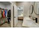 Bathroom featuring double sinks, walk in closet, and view to bedroom, all with light gray walls at 141 Ole Eastpointe Dr, York, SC 29745