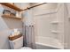 A close up of a toilet, shower and curtain featuring wooden shelves and decorations on the wall at 141 Ole Eastpointe Dr, York, SC 29745