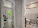 This bathroom features a wood vanity, toilet, shower and view to a room with a ceiling fan at 141 Ole Eastpointe Dr, York, SC 29745