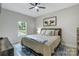 Cozy bedroom with natural light, a ceiling fan, comfortable bed, and decorative cow artwork at 141 Ole Eastpointe Dr, York, SC 29745