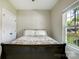 Neutral bedroom with gray walls and a ceiling fan. Features a view of a car outside the window at 141 Ole Eastpointe Dr, York, SC 29745