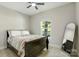 Neutral bedroom with gray walls and a ceiling fan. Features a view of trees outside the window at 141 Ole Eastpointe Dr, York, SC 29745