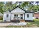 Charming white brick home with a cozy front porch, perfect for enjoying the outdoors at 141 Ole Eastpointe Dr, York, SC 29745