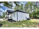 Side view of a charming white brick home featuring a cozy front porch and a manicured lawn at 141 Ole Eastpointe Dr, York, SC 29745