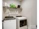 Convenient laundry room equipped with modern washer and dryer units and practical shelving at 141 Ole Eastpointe Dr, York, SC 29745