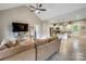 Open-concept view from living room to kitchen, complete with vaulted ceilings and stainless steel appliances at 141 Ole Eastpointe Dr, York, SC 29745