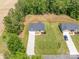 Aerial view of a home showcasing its manicured lawn, driveway, and proximity to surrounding greenery and neighborhood at 142 Highland Dr, New London, NC 28127