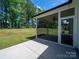View of the screened in back porch with a nice view of the grassy yard at 142 Highland Dr, New London, NC 28127