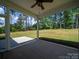 Covered back porch overlooking expansive yard and wooded area at 142 Highland Dr, New London, NC 28127