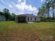 Expansive backyard featuring a covered porch and a well-maintained lawn, perfect for outdoor activities and relaxation at 142 Highland Dr, New London, NC 28127