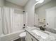 Well-lit bathroom featuring a shower-tub combo, granite vanity, and a large mirror for a clean, modern look at 142 Highland Dr, New London, NC 28127