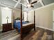Elegant bedroom with a four-poster bed, wood floors, and ample natural light creating a serene and inviting space at 142 Highland Dr, New London, NC 28127