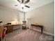 Simple bedroom with neutral colors, a ceiling fan, and natural light from the window at 142 Highland Dr, New London, NC 28127