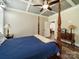 Charming bedroom featuring a four-poster bed, wood floors, and stylish decor, creating a warm and inviting retreat at 142 Highland Dr, New London, NC 28127