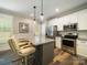 Modern kitchen with stainless steel appliances, white cabinets, and granite countertops at 142 Highland Dr, New London, NC 28127