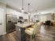 Modern kitchen with stainless steel appliances, granite countertops, a large island, and an open layout to the living area at 142 Highland Dr, New London, NC 28127