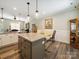 Kitchen island with granite countertops and pendant lights, with adjacent dining area at 142 Highland Dr, New London, NC 28127