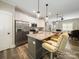 Open kitchen features stainless steel appliances, white cabinetry, and a breakfast bar at 142 Highland Dr, New London, NC 28127