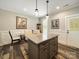 Eat-in kitchen with a granite island and seating, complemented by modern pendant lighting and stylish decor at 142 Highland Dr, New London, NC 28127