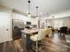 Modern kitchen with an island, stainless steel appliances, pendant lights, and an open view to the living area at 142 Highland Dr, New London, NC 28127