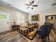 Cozy living room featuring wood floors, and comfortable seating arrangement under a ceiling fan at 142 Highland Dr, New London, NC 28127