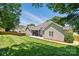 Landscaped backyard showcasing a spacious patio, well-manicured lawn, and privacy fence for outdoor enjoyment at 146 Burtons Barn Rd, Mooresville, NC 28115