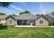 Beautifully maintained backyard featuring a well-kept lawn, a spacious patio, and a charming covered seating area at 146 Burtons Barn Rd, Mooresville, NC 28115