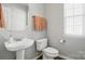 Bathroom featuring a pedestal sink and a window at 146 Burtons Barn Rd, Mooresville, NC 28115