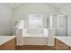 Bright bathroom featuring a soaking tub with glass block window at 146 Burtons Barn Rd, Mooresville, NC 28115
