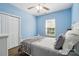 This is a secondary bedroom with a ceiling fan, neutral colors, and a double door closet at 146 Burtons Barn Rd, Mooresville, NC 28115