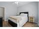 This bedroom has a neutral color palette, wooden floors, and a ceiling fan at 146 Burtons Barn Rd, Mooresville, NC 28115