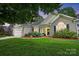 Charming single-story home with a well-manicured lawn and inviting front entrance with a beautiful front flowerbed at 146 Burtons Barn Rd, Mooresville, NC 28115