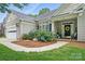 Well-maintained single-story home with a two-car garage, lovely landscaping, and a welcoming front porch at 146 Burtons Barn Rd, Mooresville, NC 28115