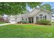 Charming single-story home with an attached garage, manicured lawn, and inviting front porch at 146 Burtons Barn Rd, Mooresville, NC 28115