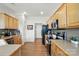 Functional kitchen with wooden cabinetry and essential appliances for cooking at 146 Burtons Barn Rd, Mooresville, NC 28115