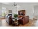 Cozy living room with fireplace, built-in shelving, and hardwood floors at 146 Burtons Barn Rd, Mooresville, NC 28115