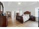 Main bedroom with coffered ceiling, hardwood floors, and an en-suite bathroom at 146 Burtons Barn Rd, Mooresville, NC 28115