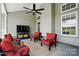 Enjoy this covered patio with outdoor ceiling fan, cushioned seating, and a television for outdoor entertainment at 146 Burtons Barn Rd, Mooresville, NC 28115