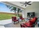 Relax on the covered patio, featuring an outdoor ceiling fan, cushioned seating, and a clear view of the lush backyard at 146 Burtons Barn Rd, Mooresville, NC 28115