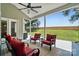 This is a comfortable covered patio with cushioned seating, a ceiling fan, and a great view of the green backyard and trees at 146 Burtons Barn Rd, Mooresville, NC 28115