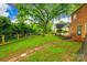 Expansive backyard with mature trees, a stone pathway, and a charming fence at 1581 Granville Rd, Rock Hill, SC 29732