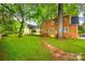 Lush backyard featuring mature trees, a stone pathway, and a well-maintained lawn at 1581 Granville Rd, Rock Hill, SC 29732